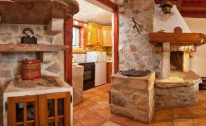 a kitchen with a large stone oven in a house at The Ultimate Escape - traditional cottage & private pool in Selca