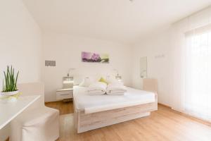 Ένα ή περισσότερα κρεβάτια σε δωμάτιο στο Hotel Garni Vinea Montis