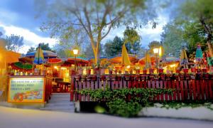 a amusement park with colorful umbrellas and a fence at Campeggio Al Bosco in Grado