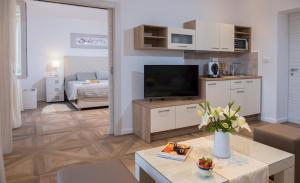 a living room with a television and a living room at Ragusina luxury apartments in Dubrovnik