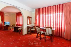 a living room filled with furniture and a tv at Hotel Premier in Cluj-Napoca