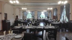 a large banquet hall with tables and chairs at Pensiune Marginimea Sibiului in Orlat