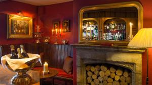 a bar with a fireplace and a mirror at Priory Wareham in Wareham