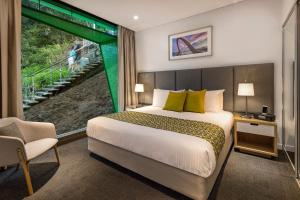 a hotel room with a bed and a window at Quest Mounts Bay Road in Perth +14 photos