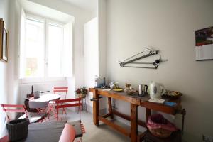 a kitchen with a table and red chairs in a room at L'architetto in Rome