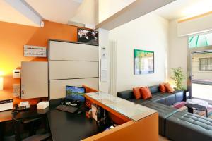 a living room with a couch and a desk at Hotel Lupori in Viareggio