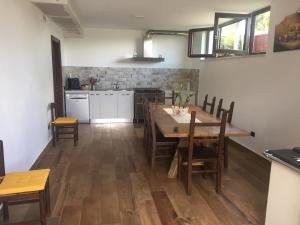 a kitchen and dining room with a wooden table and chairs at casa nostra in Ceraso +34 photos