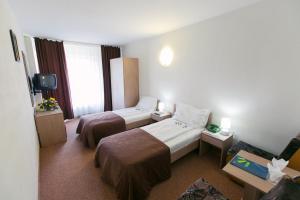 Postel nebo postele na pokoji v ubytování Hotel Mures