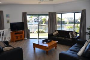 a living room with a couch and a coffee table at Bayz Maroochy Waters in Maroochydore
