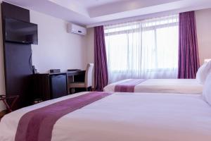 Ein Bett oder Betten in einem Zimmer der Unterkunft Gelian Hotel