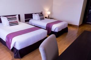 Ein Bett oder Betten in einem Zimmer der Unterkunft Gelian Hotel