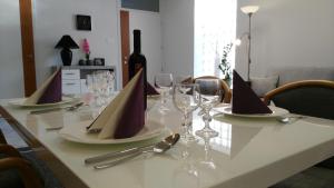 a table with wine glasses and napkins on it at Füredi Ház apartman in Sopron