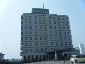 a building with a sign on the top of it at Hotel Route-Inn Odate Omachi in Odate