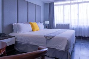 Ein Bett oder Betten in einem Zimmer der Unterkunft Gelian Hotel
