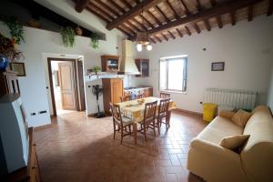 a kitchen and living room with a table and chairs at Agriturismo Casone in Montefiascone