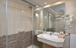 a bathroom with a sink and a glass shower at Sol Torremolinos - Don Pablo in Torremolinos