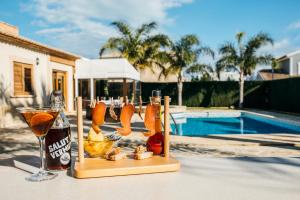 a table with a drink and a bottle of beer at Hotel La Gastrocasa - Adults Only in Gandía