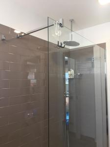 a shower with a glass door in a bathroom at Attico al Mare in Lido di Ostia