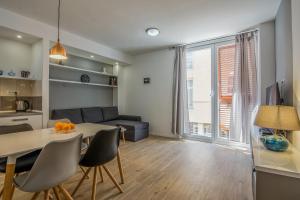 a living room with a table and a couch at Bell Apartment in Zadar