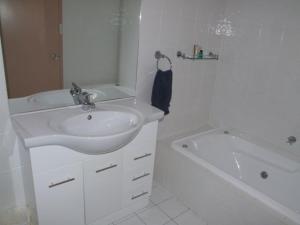 a white bathroom with a sink and a bath tub at Streaky Bay Hotel Motel in Streaky Bay