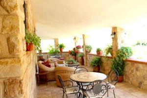 a patio with a table and chairs and plants at Casale Orioles in Torretta