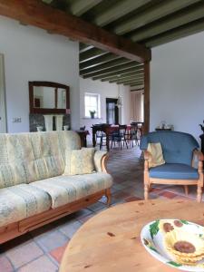 a living room with a couch and a table at Boerderij & Bakhuis in Liempde