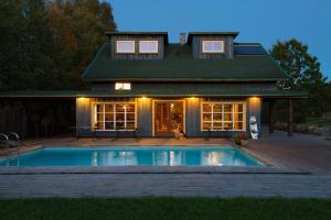 a house with a swimming pool in front of a house at Tuisuliiva Holiday House in Kabli