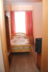 a bedroom with a bed in front of a window at Apartment U bashni in Murom