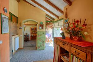 a room with a kitchen with a table and a hallway at Casa Dolce Casa in Vercana