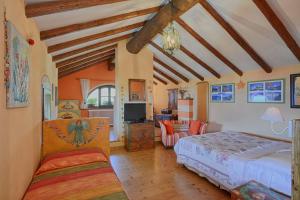 a bedroom with a bed and a living room at Casa Dolce Casa in Vercana