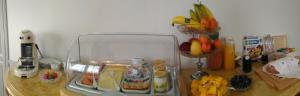 a counter top with a glass container with fruits and vegetables at Le Jardin Des Erables in Saint-Marcel