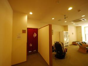 an office hallway with a red door and a chair at Hotel Route-Inn Tokoname Ekimae in Tokoname