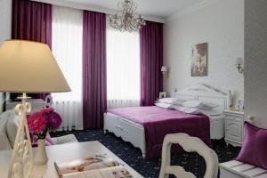 a hotel room with a bed and a table at Gostiny Dvor Hotel in Kharkiv