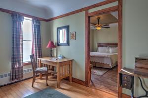 a bedroom with a bed and a desk and a mirror at Country Encounters Accommodations in Coleman