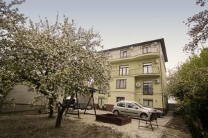 a white car parked in front of a building at Potocki Apartments in Lviv