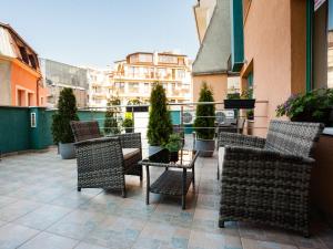 a patio with chairs and tables on a balcony at Bright House in Plovdiv +17 photos