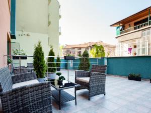 a patio area with chairs, tables, chairs and tables at Bright House in Plovdiv