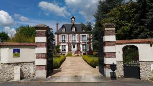 an entrance to an old house with a gate at Le Jardin Des Erables in Saint-Marcel +20 photos