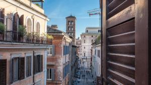 a city street with a clock tower in the distance at Rental in Rome - Gambero Suite in Rome