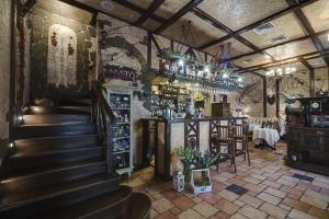 a restaurant with a bar and a staircase in a room at Gostiny Dvor Hotel in Kharkiv