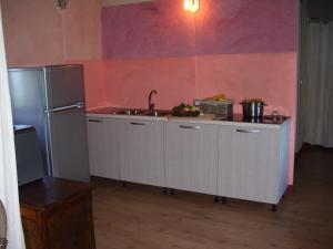 a kitchen with a sink and a refrigerator at Il Sartù in Dogliani