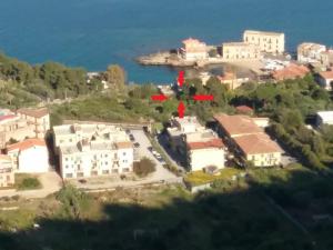 an aerial view of a village with houses and the water at Casa Mimi in Santa Flavia