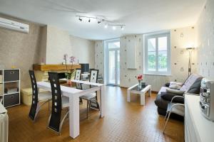 a living room with a table and a couch at Gîte L'Hirondelle in Castelnau-de-Médoc +16 photos