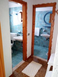 a bathroom with a toilet and a sink and a shower at Albergo Al Pino in Enego