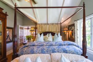 a bedroom with a bed with a canopy at Arabella Laguna in Laguna Beach