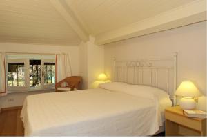 a bedroom with a white bed and a window at La Spiaggia in Oliveto Lario +38 photos