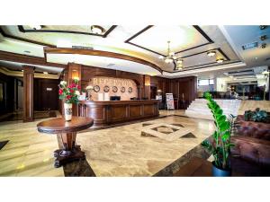 a lobby with a table with flowers on it at Park Hotel and SPA Vella Hills in Velingrad