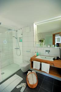 a bathroom with a shower and a sink and a toilet at Hotel Grüner Wald in Freudenstadt