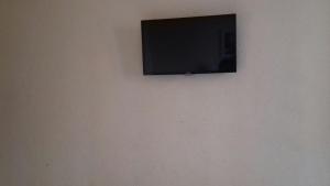 a flat screen tv hanging on a wall at Hotel Michel in São Paulo