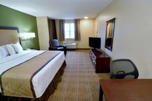 a hotel room with a bed and a television at Extended Stay America Suites - Sacramento - Northgate in Sacramento